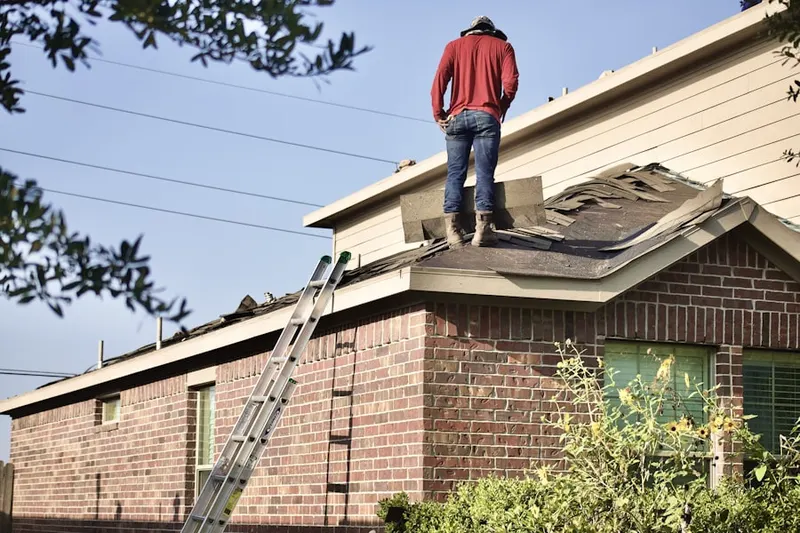 Professional roofer working on a residential roof in Anderson Creek